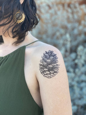 Show off your love of nature with these great temporary tattoos.  Pinecone temporary tattoo, original design, hand-drawn in black lines. This familiar woody seed pod will become a towering pine tree over half of a century. The pinecone is one beginning and represents awareness and presence.