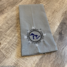 Load image into Gallery viewer, This beautiful grey tea towel features a Great Lakes design embroidered within a compass face.