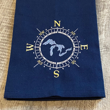 Load image into Gallery viewer, This beautiful navy blue tea towel features a Great Lakes design embroidered within a compass face.
