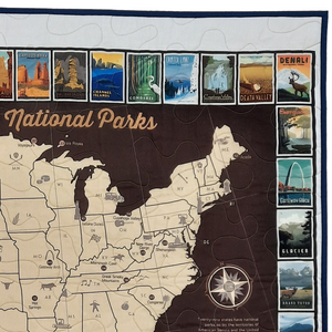 Commemorate your love of the National Parks with this handmade quilted wall hanging. The intricate design is crafted to last, becoming a timeless addition to any home decor or as a treasured gift.   Easily commemorate your travels with additional hand-stitching or pins.  This panel features a map of the national parks in the United States of America bordered by national park posters. Made in Wisconsin, USA by AdventureUs