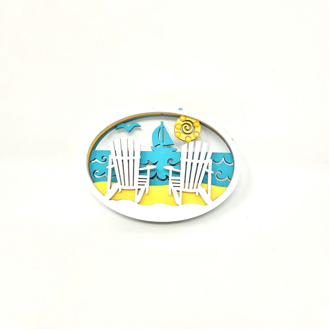 Lakeside Sailing Souvenir Magnet complete with Adirondack Chairs  This beautiful layered wood cut magnet is the perfect souvenir from your Lake Superior adventures in iconic Apostle Islands, Bayfield, Washburn, and Ashland -  Wisconsin.  Size: 3