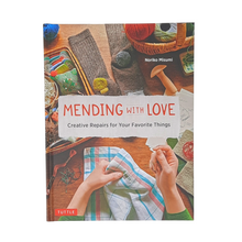 Load image into Gallery viewer, Mending With Love shows you how to apply embroidery, patching, darning, felting, stamping and a little crochet to worn pieces of clothing or household items.  88 pages By Noriko Misumi Hardcover Size: 10.25&quot; x 7.75&quot; x 0.5&quot;