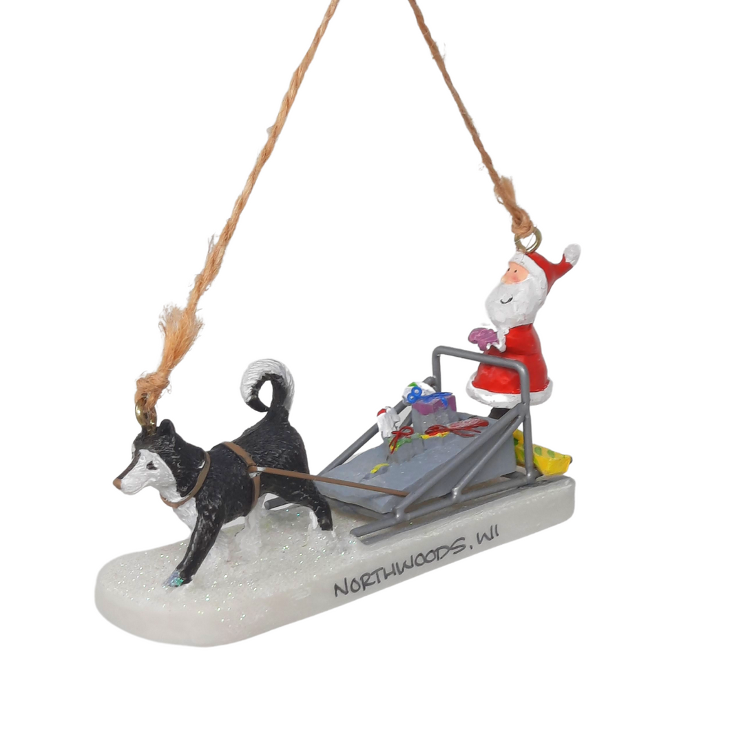 Reminisce about your Northwoods life with this beautiful holiday ornament. Perfect souvenir from your Northwoods, Wisconsin adventures in iconic Apostle Islands, Bayfield, Washburn, and Ashland areas. Santa's making a special delivery with the help of his husky dog friend Size: 2