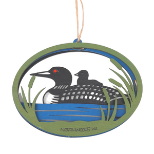 Reminisce about your Northwoods life with this beautiful holiday ornament. Perfect souvenir from your Lake Superior adventures in iconic Apostle Islands, Bayfield, Washburn, and Ashland areas in Wisconsin. Woodcut scene of a loon and chick in the cattails. Size: 5" x 3.5"