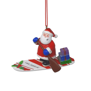 Reminisce about your Northwoods life with this beautiful holiday ornament. Perfect souvenir from your Lake Superior adventures in iconic Apostle Islands, Bayfield, Washburn, and Ashland areas. Santa on a stand up paddleboard Size: 3.5" x 2"