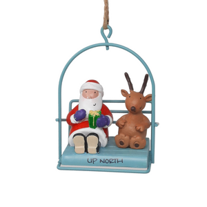 Reminisce about your Northwoods life with this beautiful holiday ornament. Perfect souvenir from your Up North adventures in iconic Apostle Islands, Bayfield, Washburn, and Ashland areas. Santa and a reindeer in a chairlift Size: 2.5" x 3"