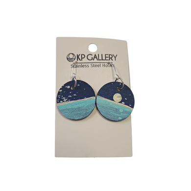 Elevate your winter wardrobe with these stunning handcrafted earrings from KP Gallery. A local artist captures the beauty of the winter night sky in perfect detail, each featuring a lake and moon painted with exquisite precision. A luxurious addition to your collection, each pair is a classic reminder of Lake Superior's unforgettable beauty.